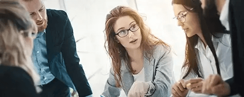A businesswoman talking to a group of people